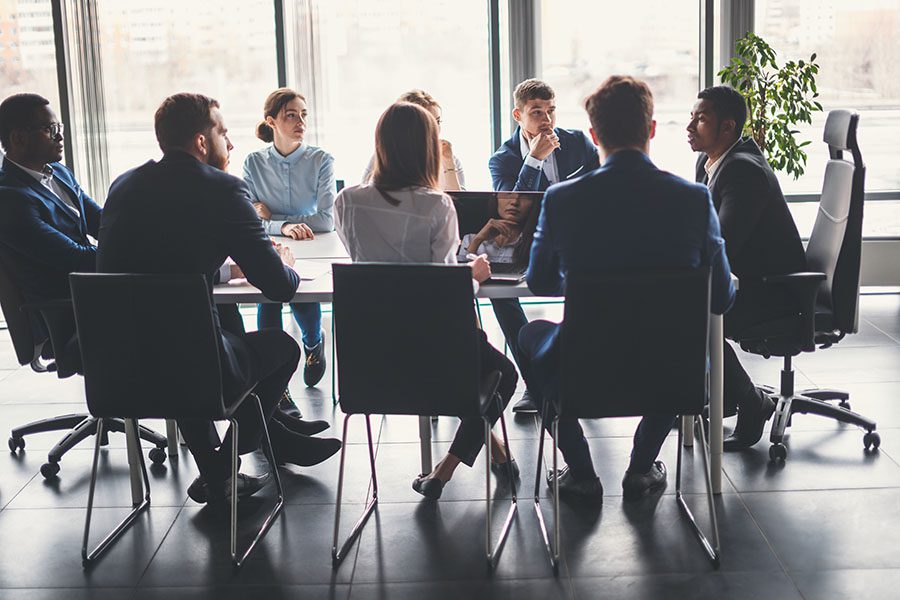 Commercial Insurance - Group of Employees Sitting in Modern Office During Business Meeting